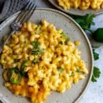 Cheesy noodles on a plate with a fork.