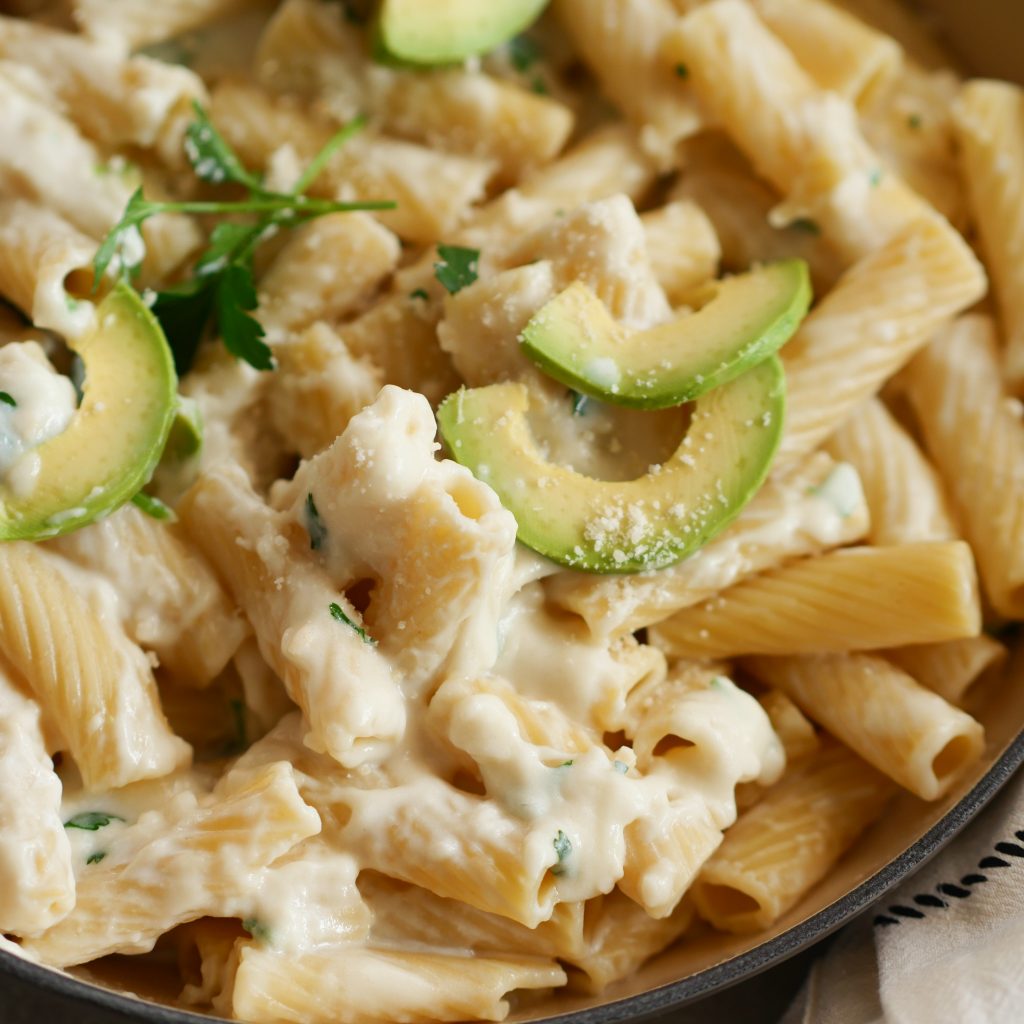 Creamy Garlic Parmesan Pasta up close with slices of avocado over the top.