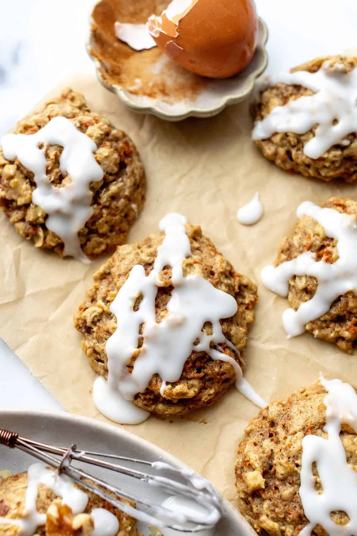 Close up photo of carrot cake cookies on parchment paper.