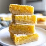 Lemon Cookie Bars stacked on each other on a plate.