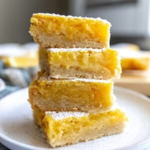 Lemon Cookie Bars stacked on each other on a plate.