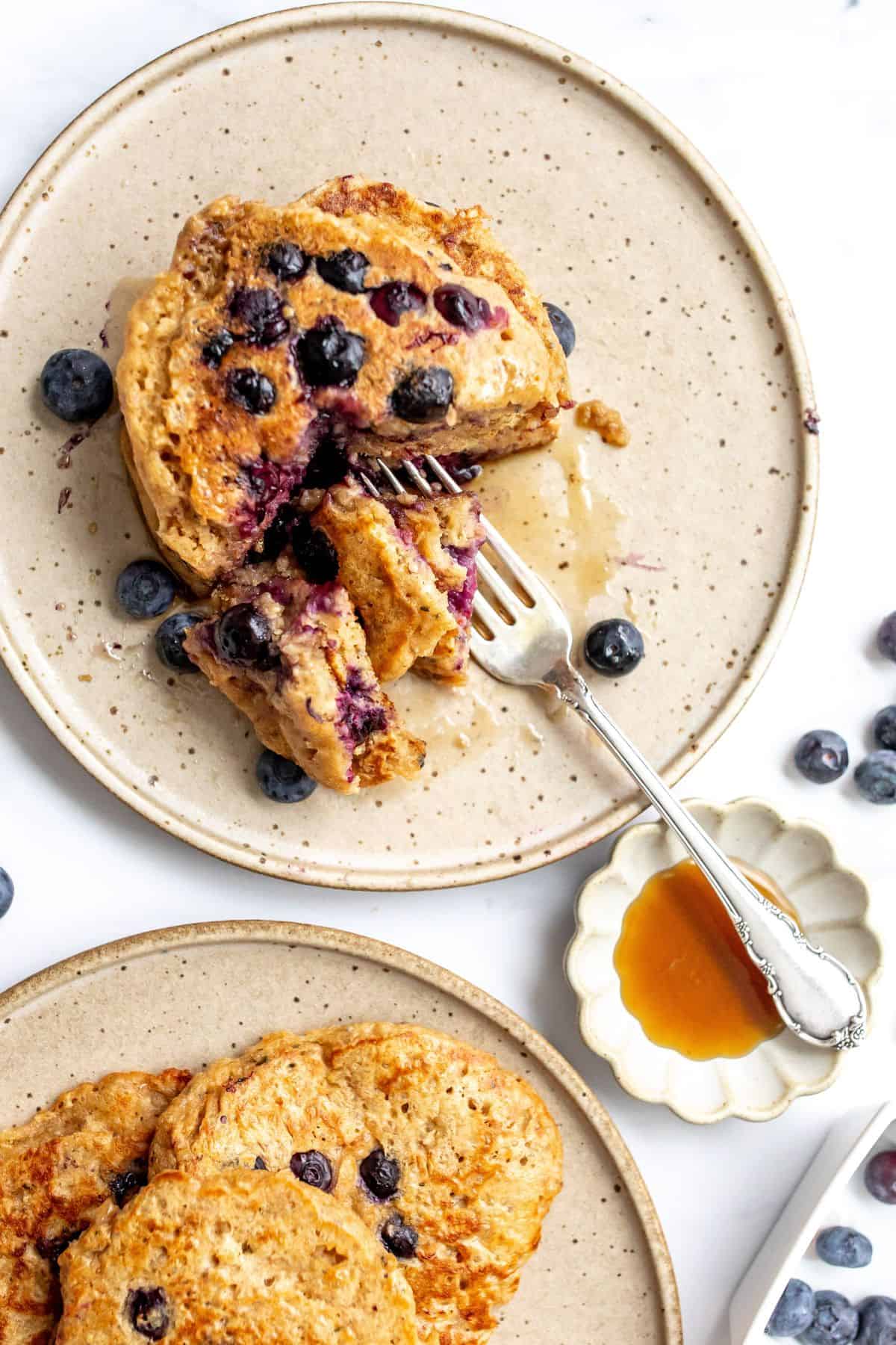 healthy whole wheat pancakes with berries and a silver fork.