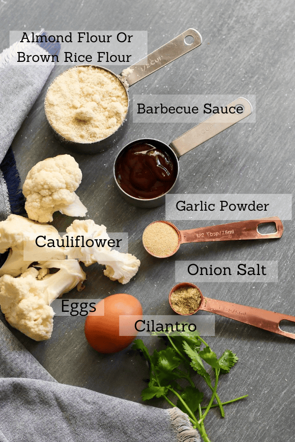 All the ingredients for this recipe layer out. Cauliflower, Garlic powder, onion powder, eggs, bbq sauce, almond flour