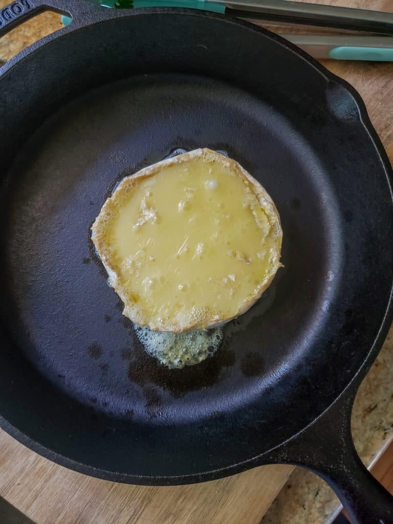 Baked brie with bubbles and change in color to show it is finished baking, 