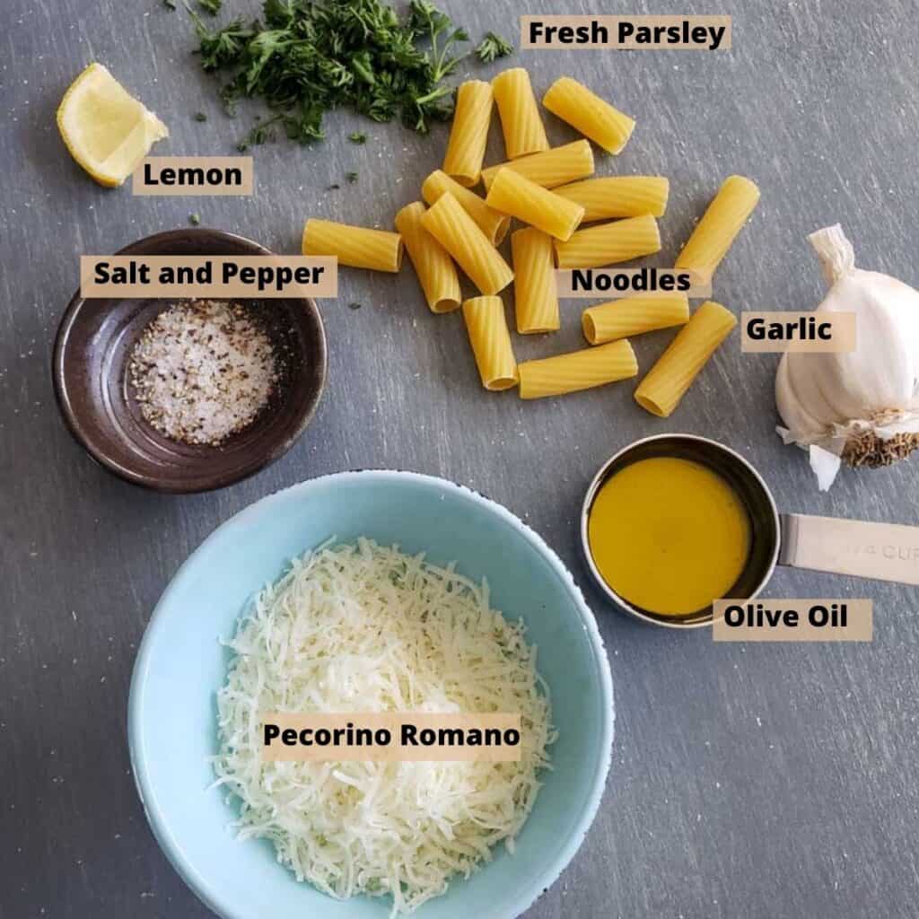 All the ingredients needed for the Healthier Cacio e PePe. Pasta, salt and pepper, garlic, olive oil, pecorino, lemon, parsley.