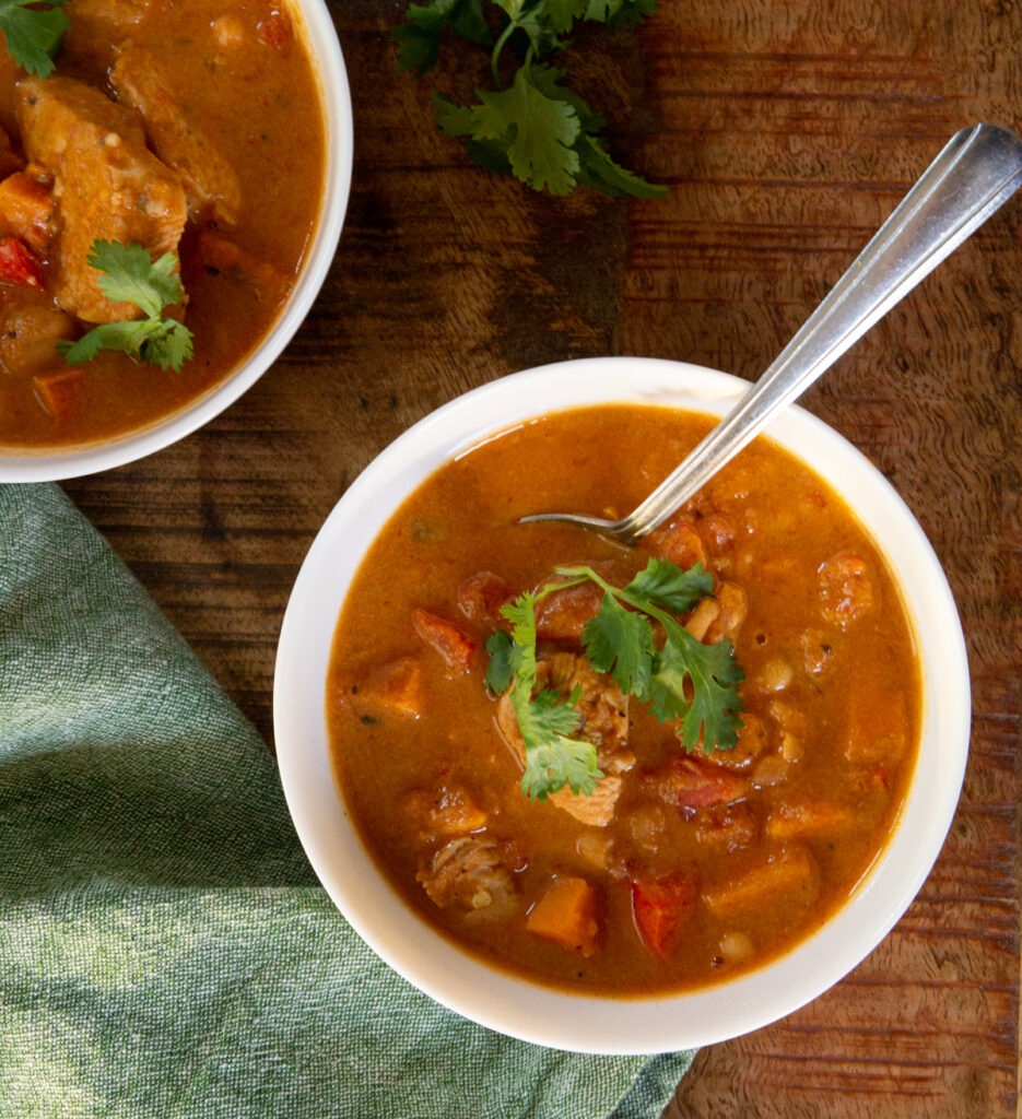 Sweet Potato Stew in a white bowl served with cilantro over the top. 