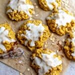 Pumpkin Pie Cookies on parchment paper with oats on the side.