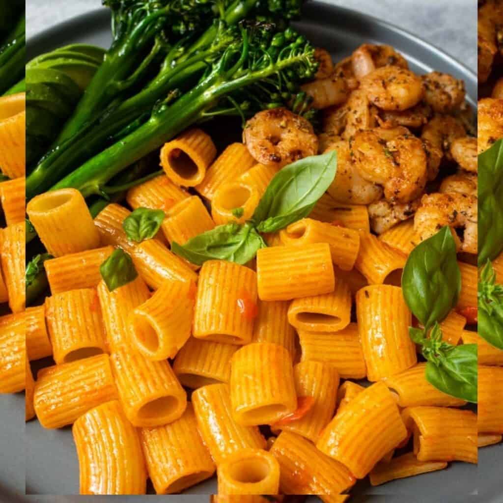 Close up photo of shrimp and pasta on a gray plate. 