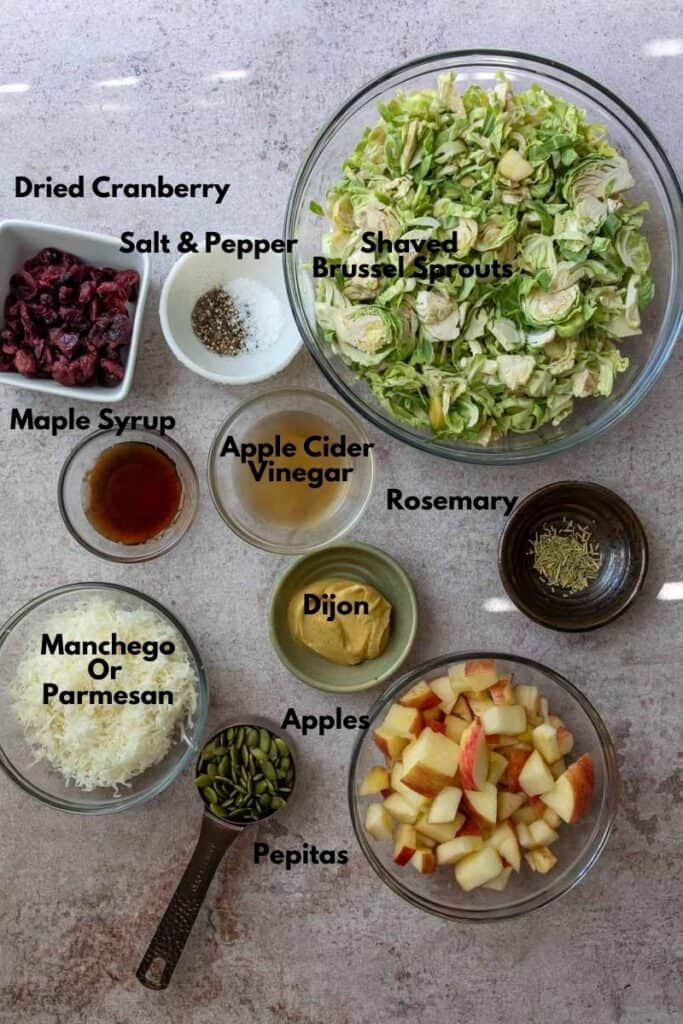 Brussel Sprout Salad With Cranberries Ingredients on a counter. 