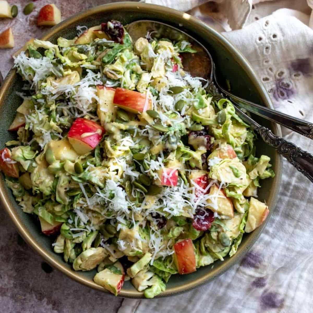 Finished Brussel Sprout Salad in a green bowl. 