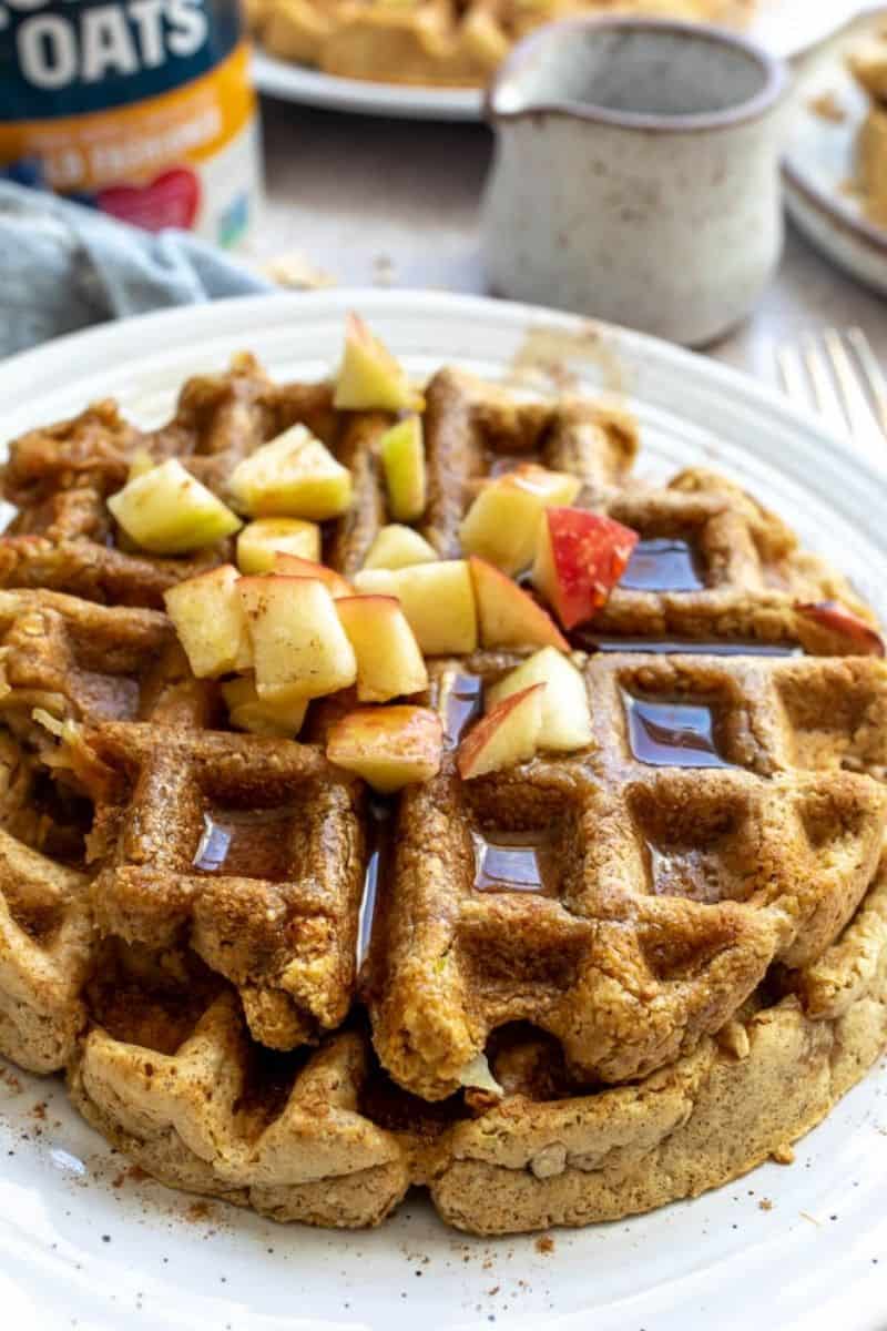 Up close photo of apple waffles with apple syrup.