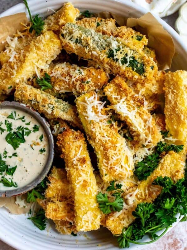 Air fryer Zucchini fries on a plate with dip.