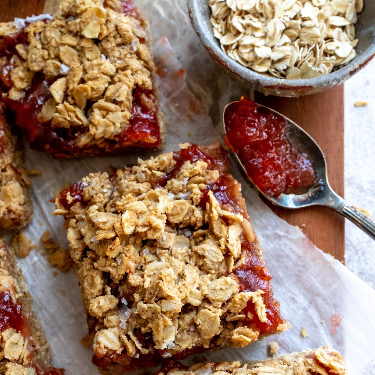 Peanut Butter Jelly Bars up close on a cutting board. 