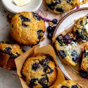 Banana Blueberry Muffins on a plate with butter.