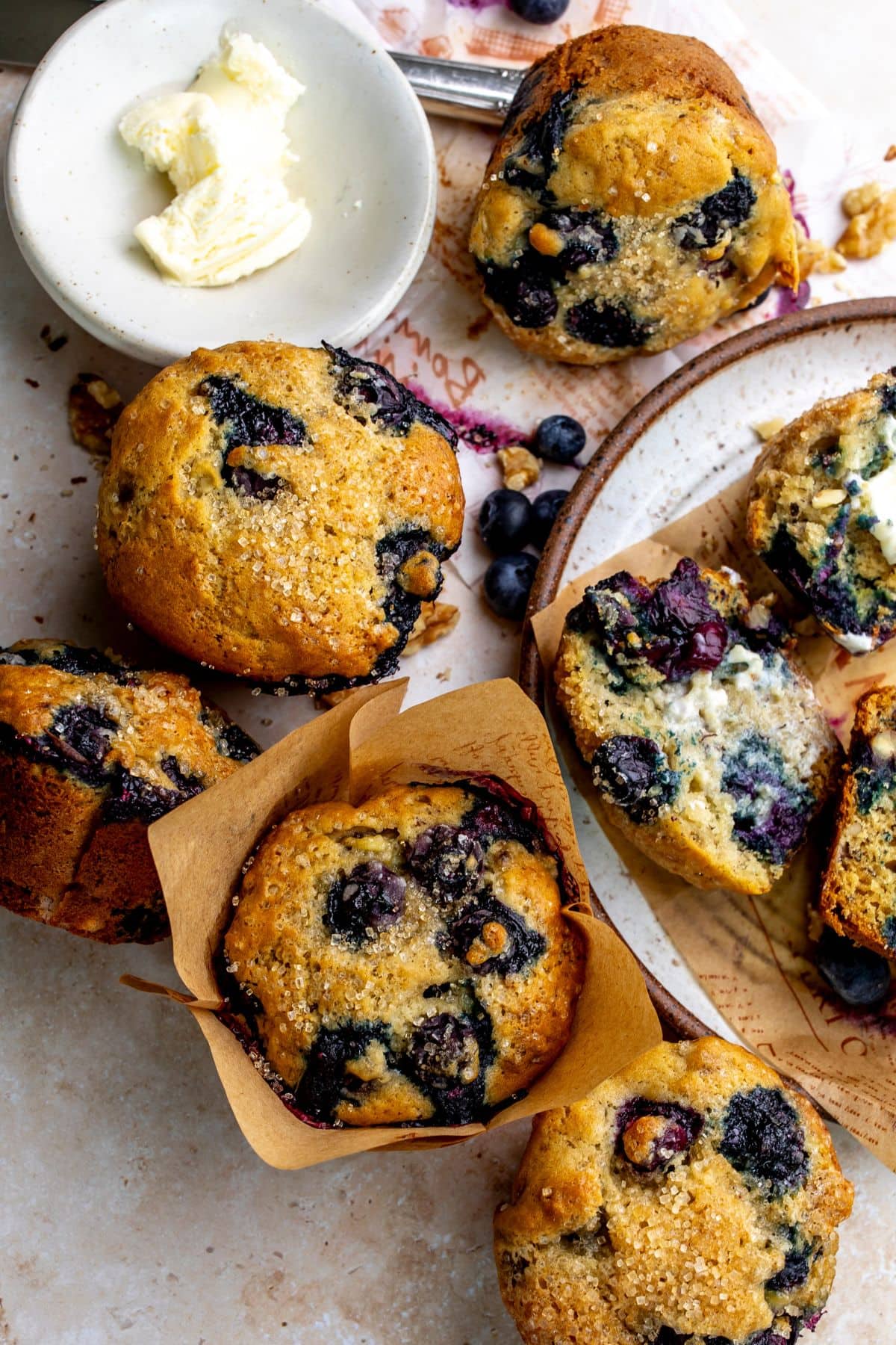 Banana Blueberry Muffins on a plate with butter.