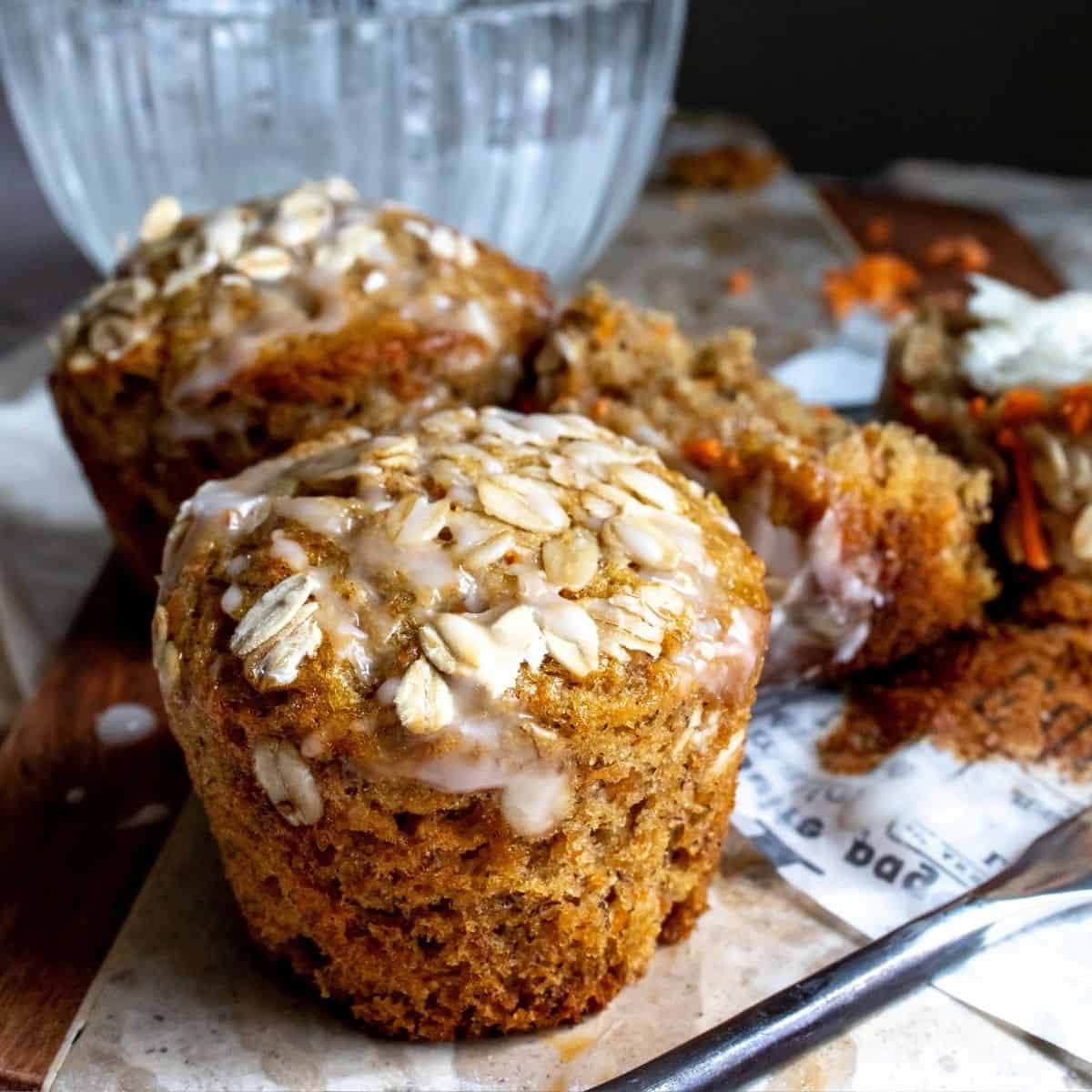 Carrot Cake Muffins up close on a cutting board.