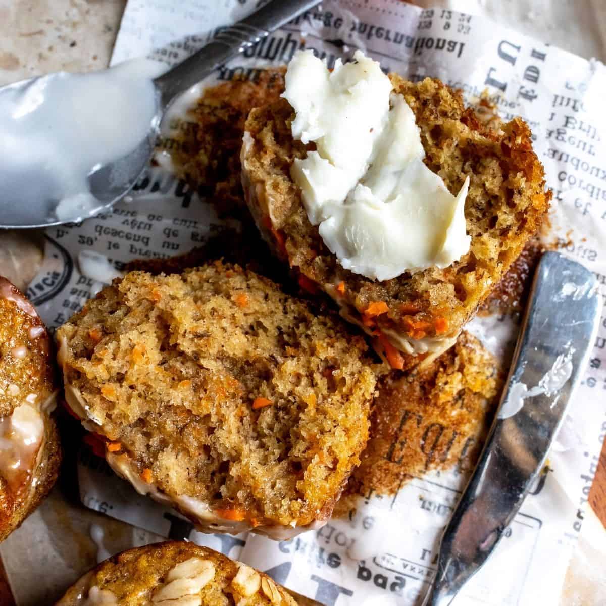 Up close photo of carrot cake muffins with butter on them.