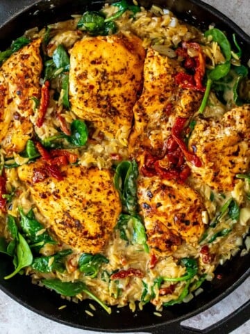 Chicken and orzo skillet with sun dried tomatoes and spinach.