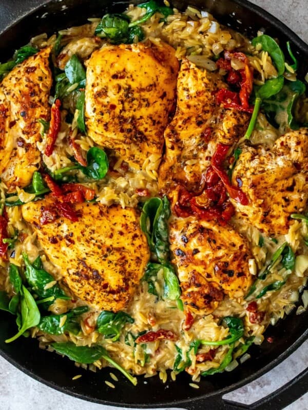Chicken and orzo skillet with sun dried tomatoes and spinach.