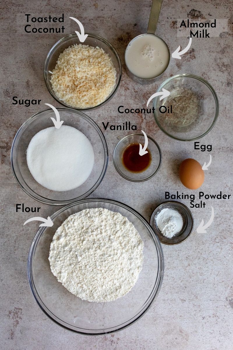 Ingredients for coconut bread in bowls on a counter.