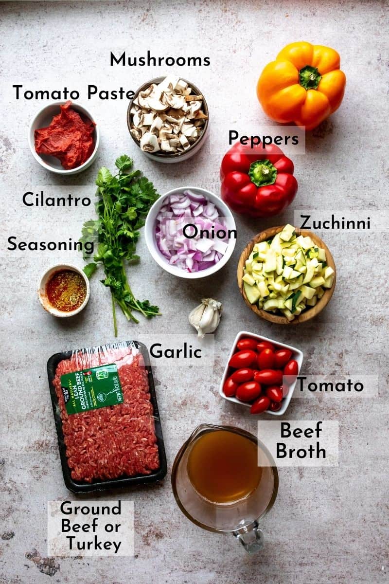 Mexican Stuffed Peppers ingredients on a gray counter in bowls. 