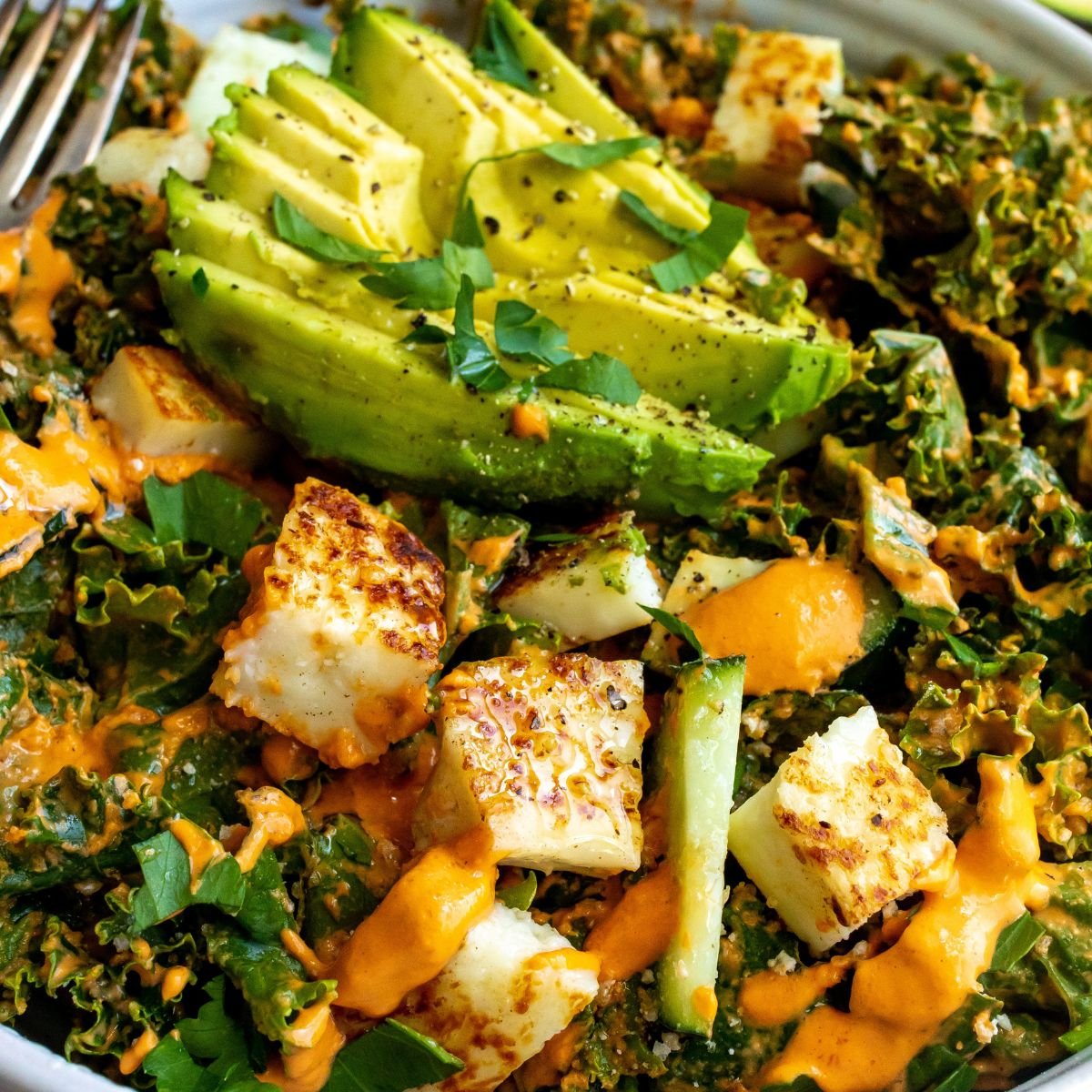 Kale Salad With Roasted Red Pepper Dressing up close in a bowl. 