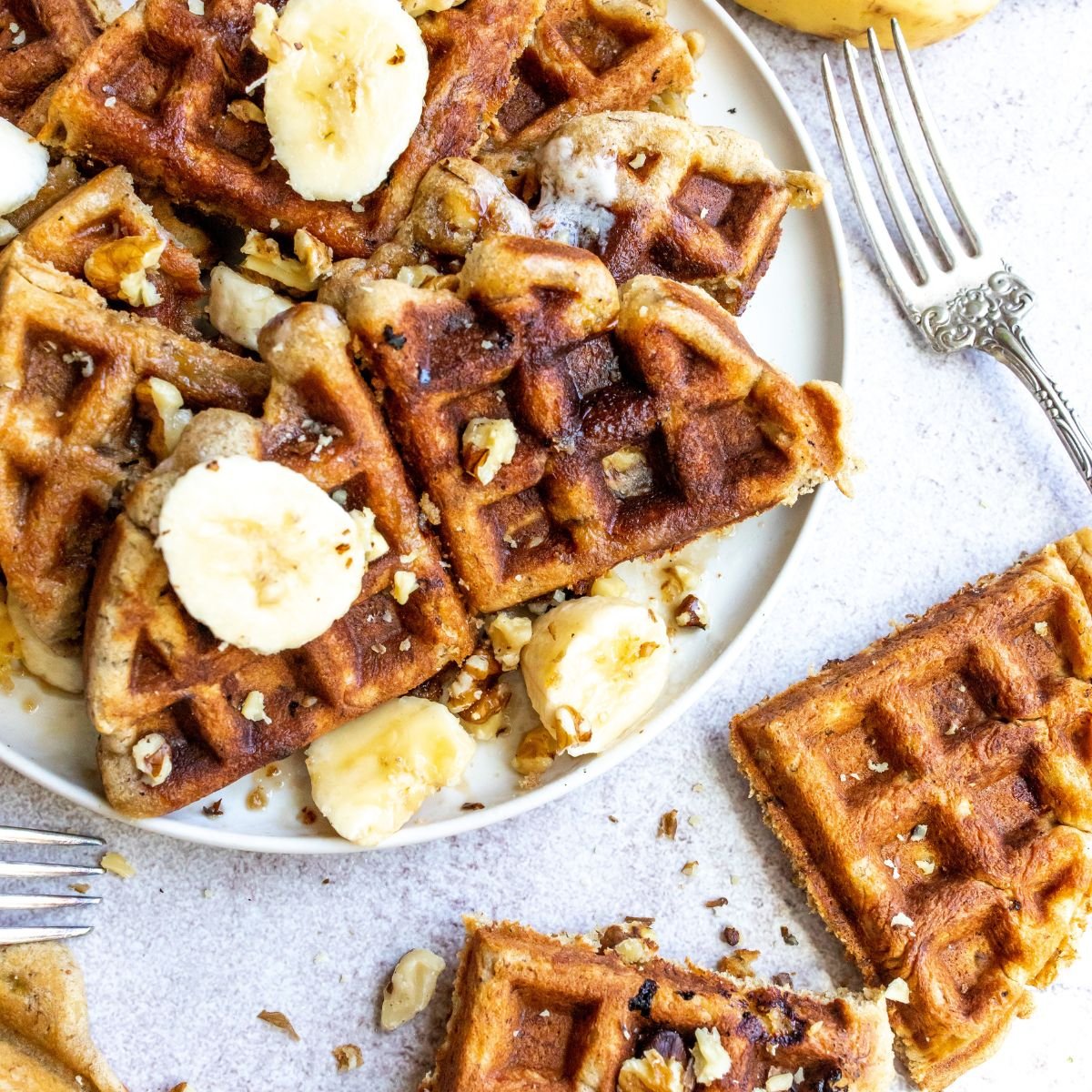 Banana Bread Waffles on a white plate with butter.