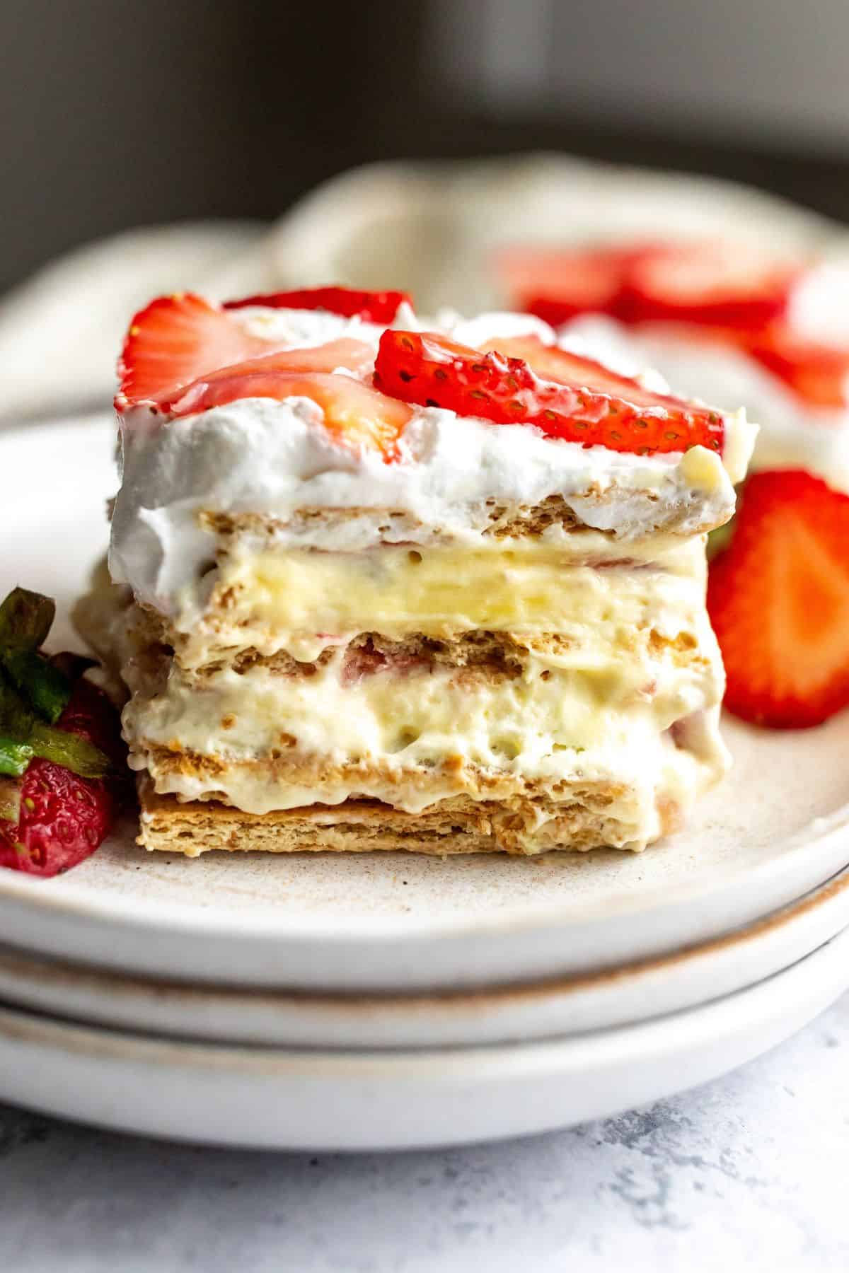 Strawberry Icebox Cake on a several white plates with a silver fork.