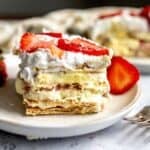 Strawberry Icebox Cake on a several white plates with a silver fork.