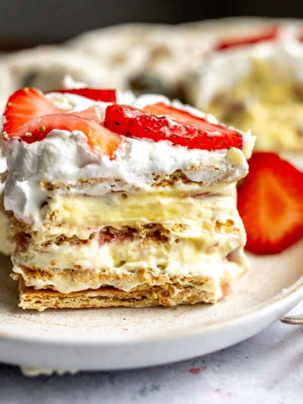 Strawberry Icebox Cake on a several white plates with a silver fork.