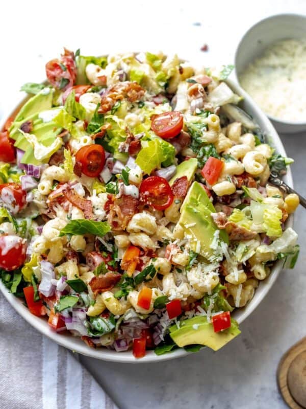 BLT Pasta Salad in a white bowl with a big spoon