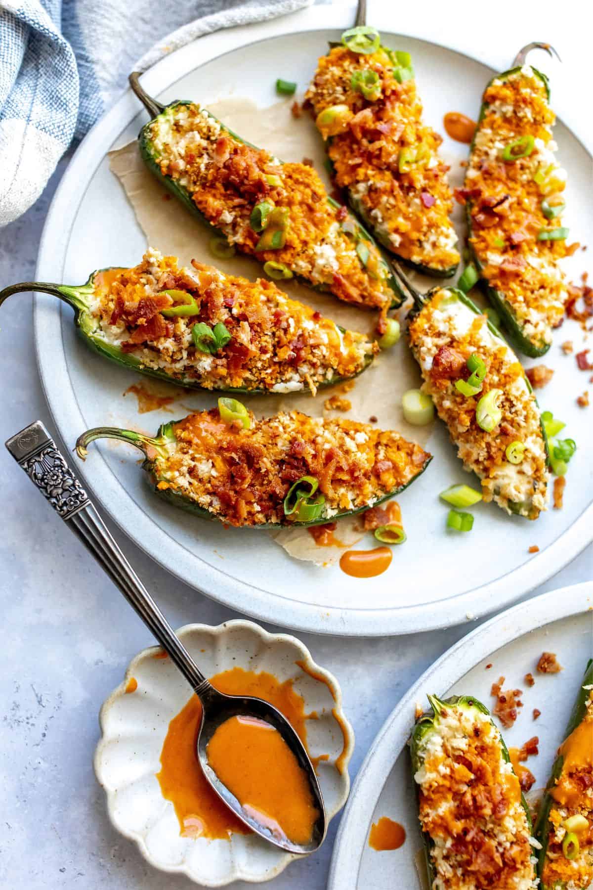 Baked Jalapeño Poppers on a plate with a spoon on the side.