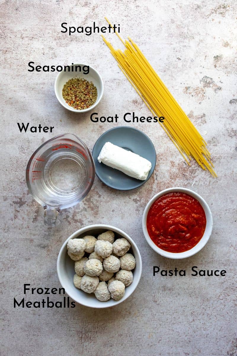 Baked Spaghetti And Meatballs ingredients on a counter in small dishes. 