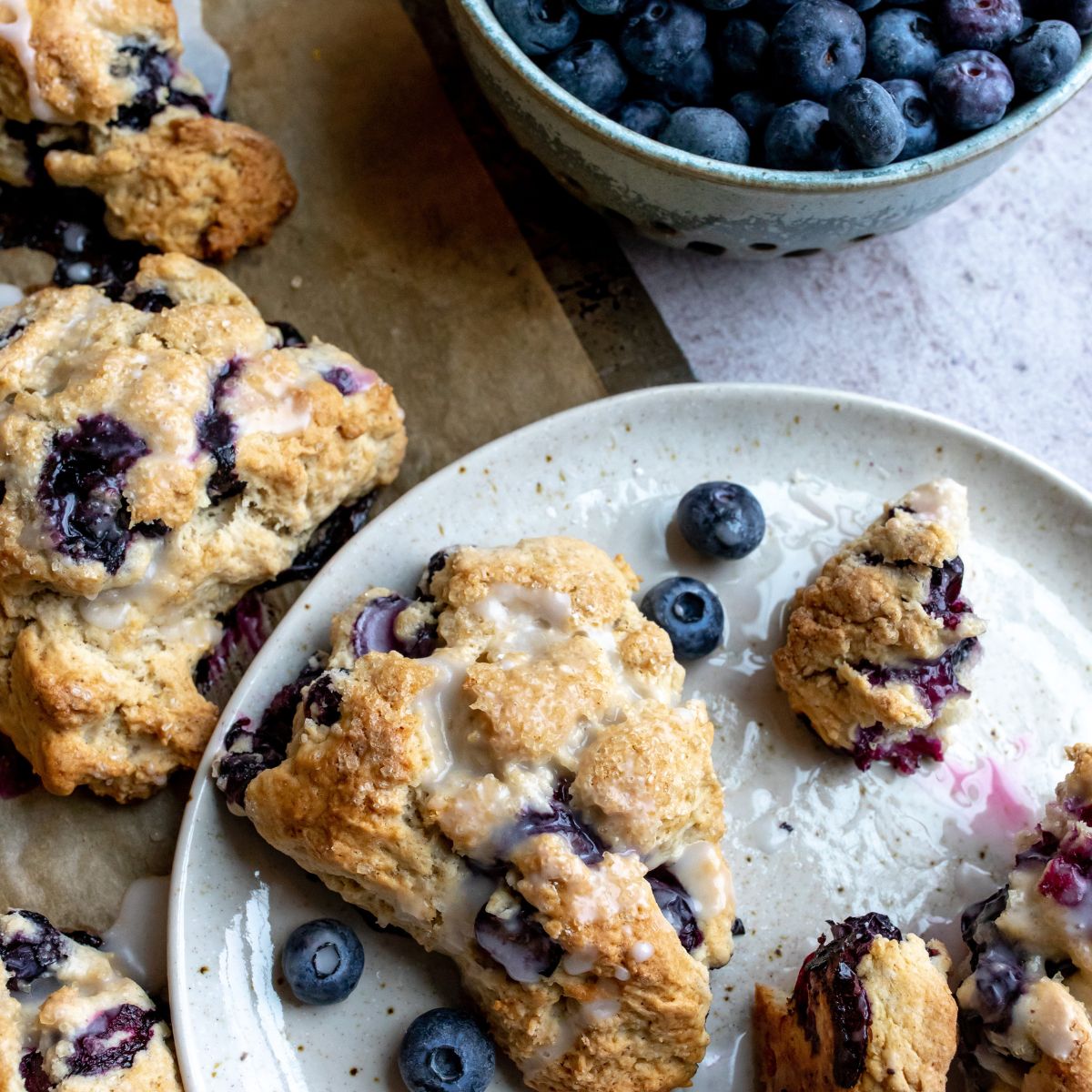 Blueberry Scones on a white plate with icing.