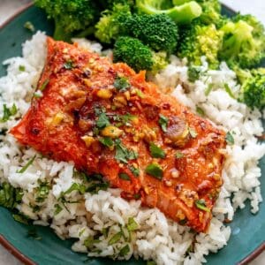 green plate with firecracker salmon on top and broccoli.