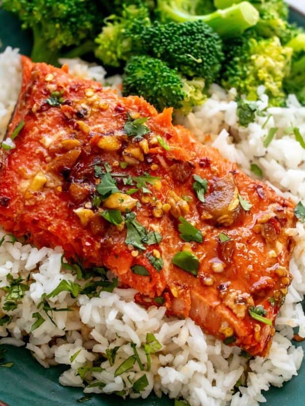 green plate with firecracker salmon on top and broccoli.