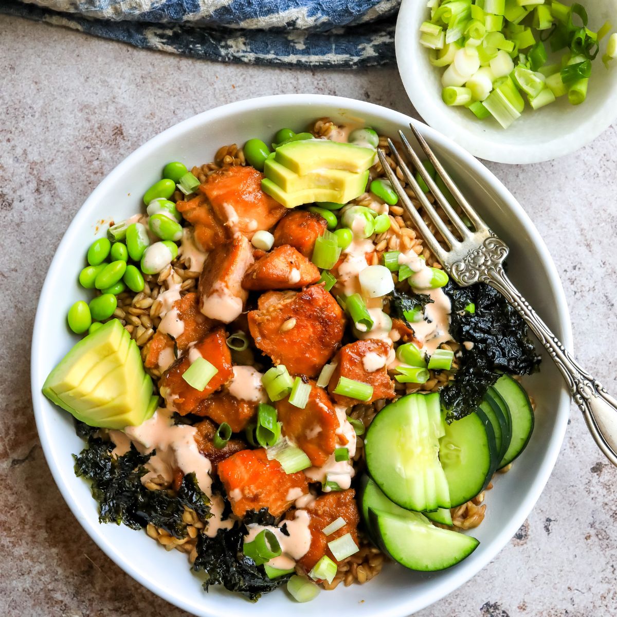 Teriyaki Salmon bowls in a white bowl with a fork.
