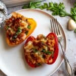 Italian Stuffed Peppers on a white plate with a fork.