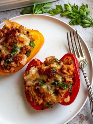 Italian Stuffed Peppers on a white plate with a fork.