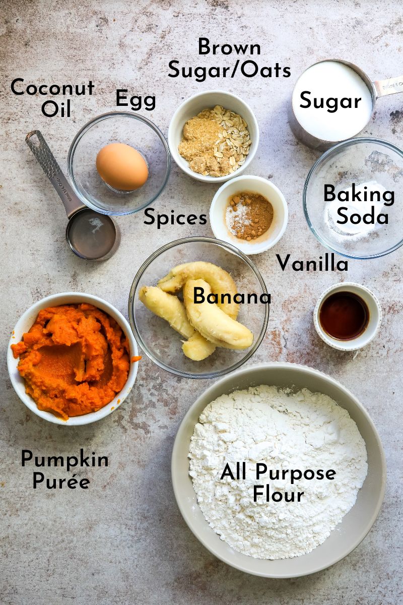 Pumpkin Banana Muffins ingredients on a counter in bowls. 