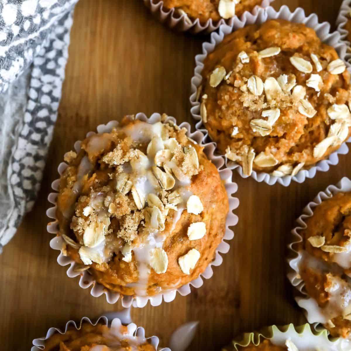 Pumpkin Banana Muffins on a cutting board with icing.
