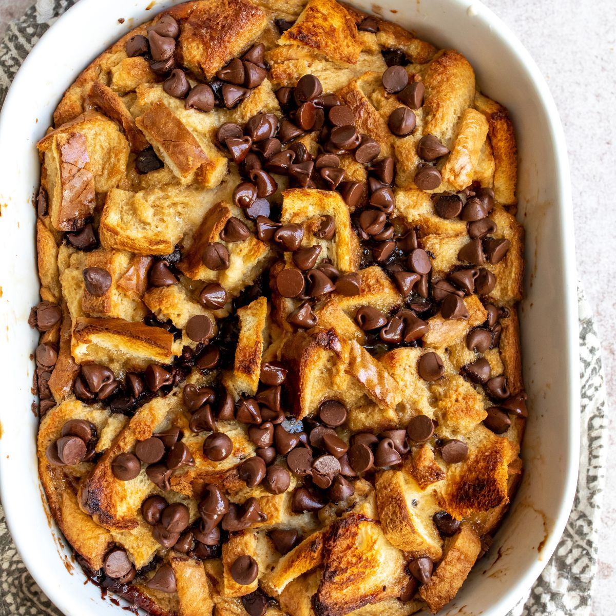 Chocolate Chip Bread Pudding up close in a casserole dish. 