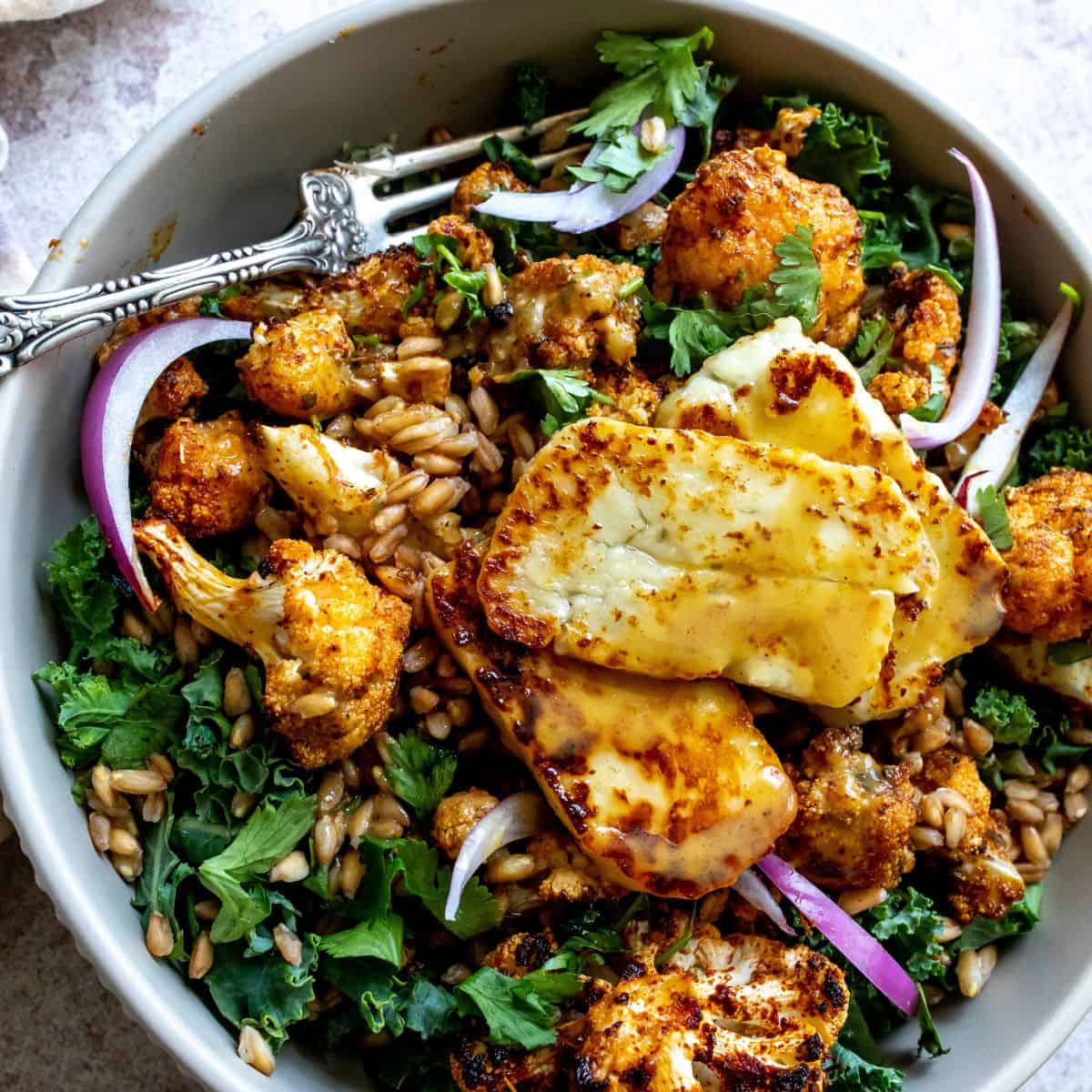 Farro Bowls with halloumi and dressing on top. 