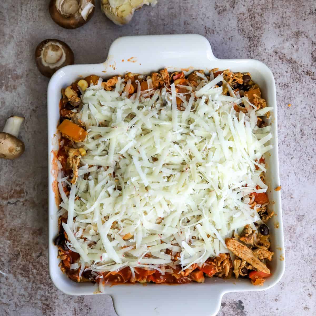 Healthier Enchilada Casserole steps with cheese on top. 