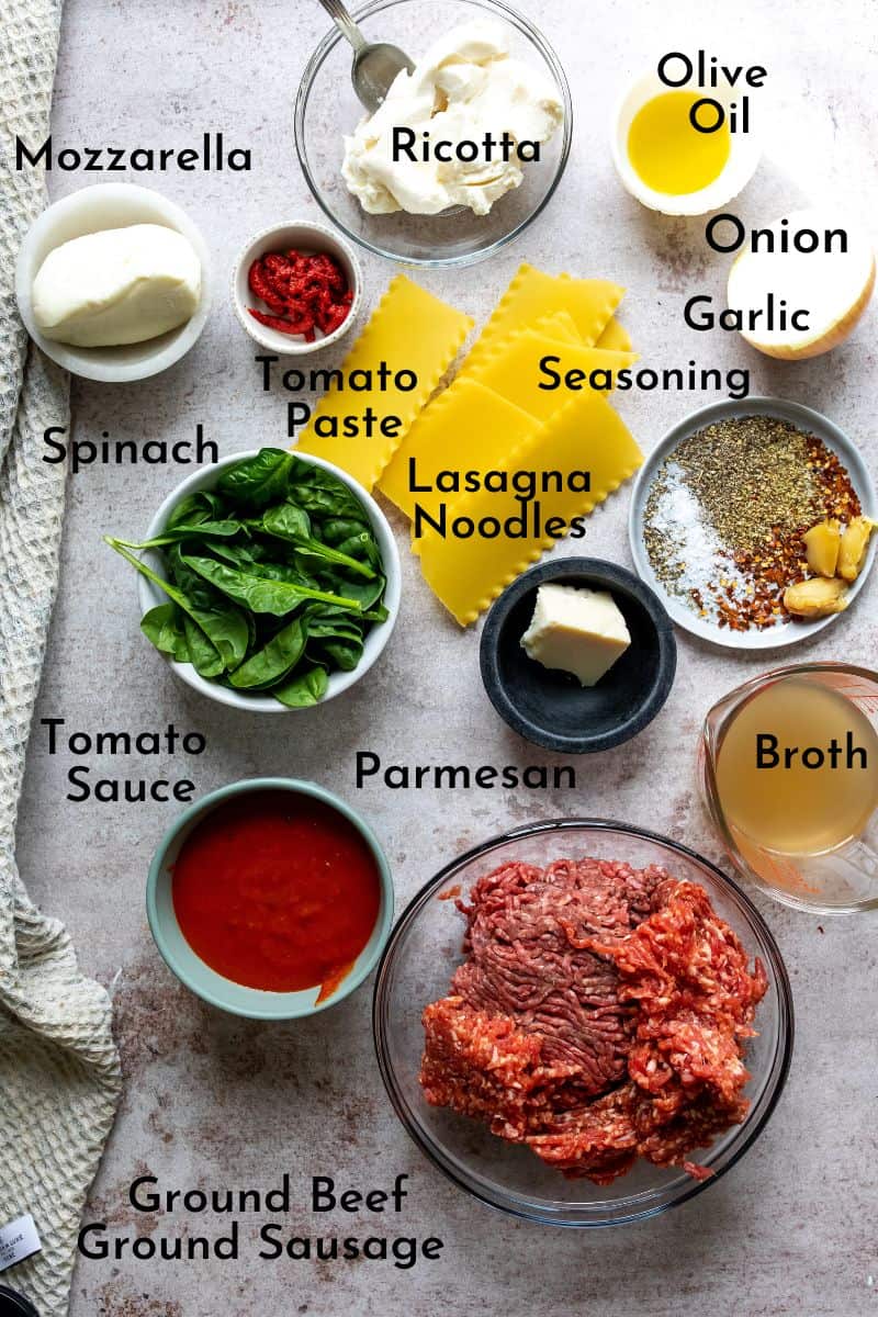 Ingredients to make One Pot Lasagna Soup on a counter, in bowls. 