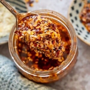 Chili onion crunch in a jar with a spoon.
