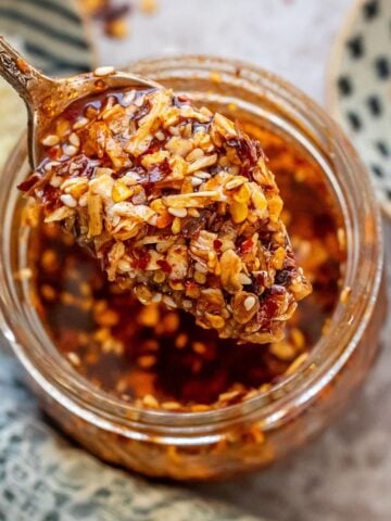 Chili onion crunch in a jar with a spoon.