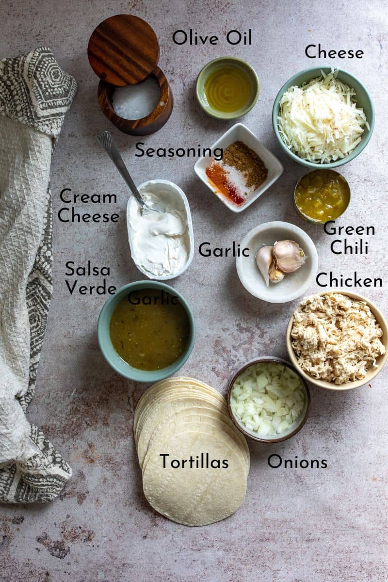 Green Chili Chicken Enchiladas ingredients on a counter in bowls. 
