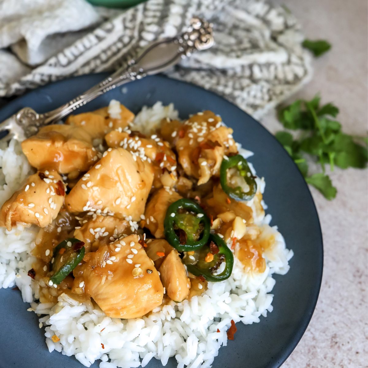 Jalapeño Chicken over white rice on a grey plate. 