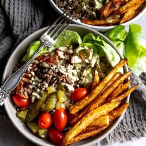 Burger Bowls in a white bowl with a silver fork.